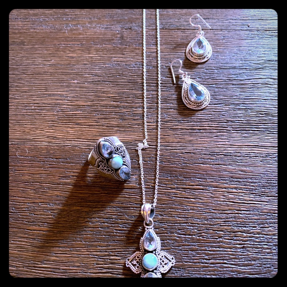 Artisan silver with blue topaz set